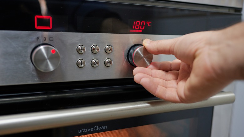 Person preheating oven