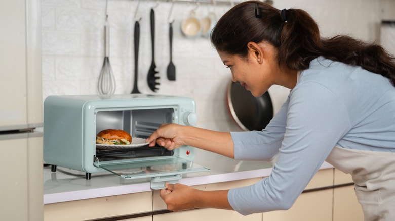 Person placing dish in oven