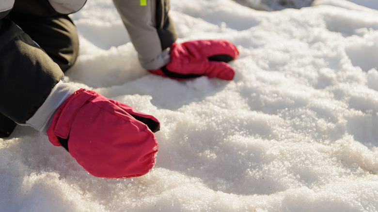 pink mittens in snow