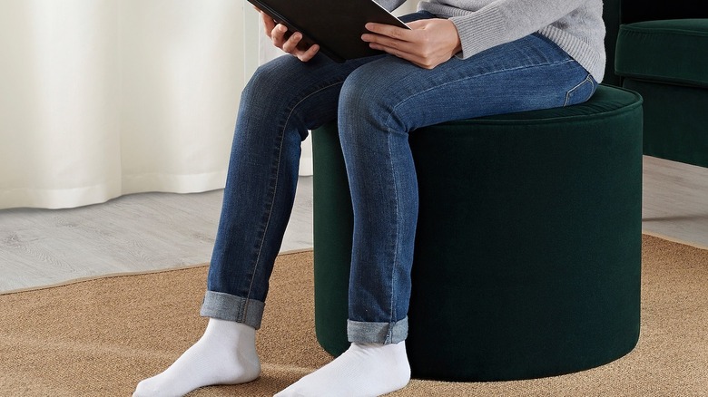 Woman sitting on green cushion 