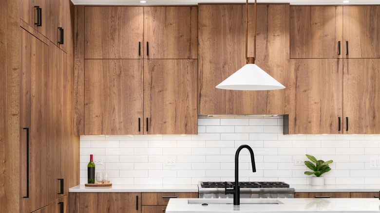 A kitchen with wood cabinets