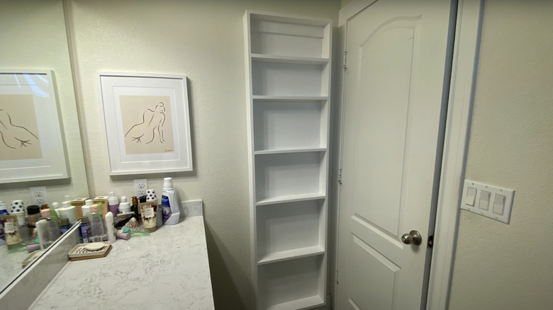 Slimline shelves installed behind the door in a bathroom