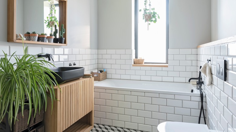 A stylish bathroom featuring white subway tiles and sleek fixtures