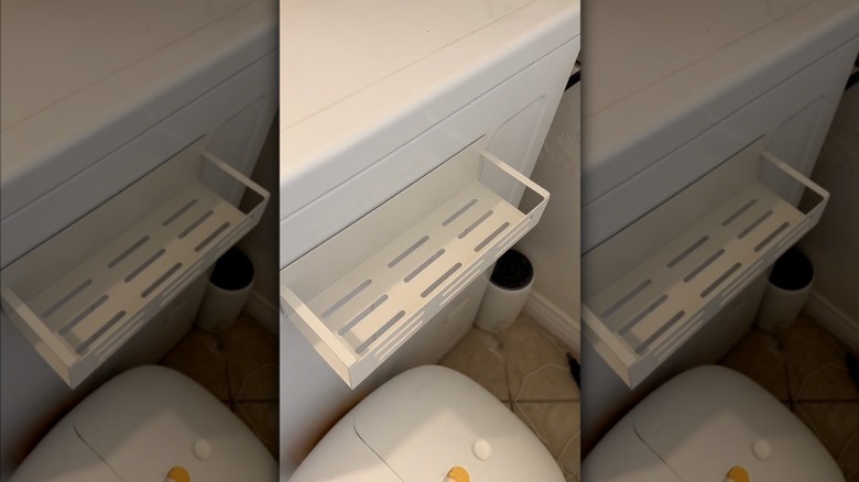 Magnetic shelves installed on metal-sided vanity next to the toilet