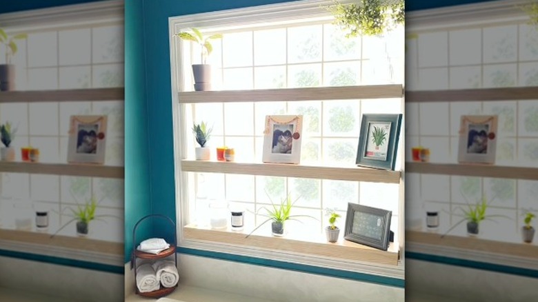 Shelves mounted into a window frame in the bathroom