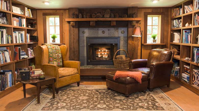 Rustic cabin living room with armchairs in front of an indoor fireplace