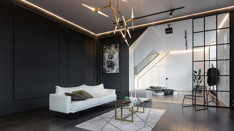 Dark and stark modern minimalist room with black accent wall