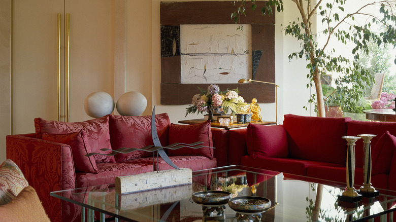 Transitional-style seating area with cozy red loveseats