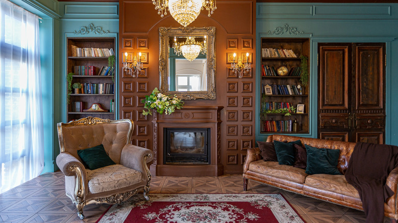 Traditional living room with armchairs, bookshelves, and intricately patterned rug