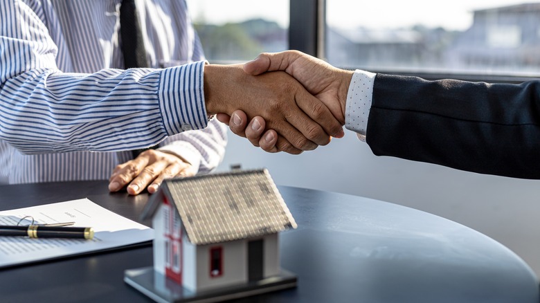 handshake over model home