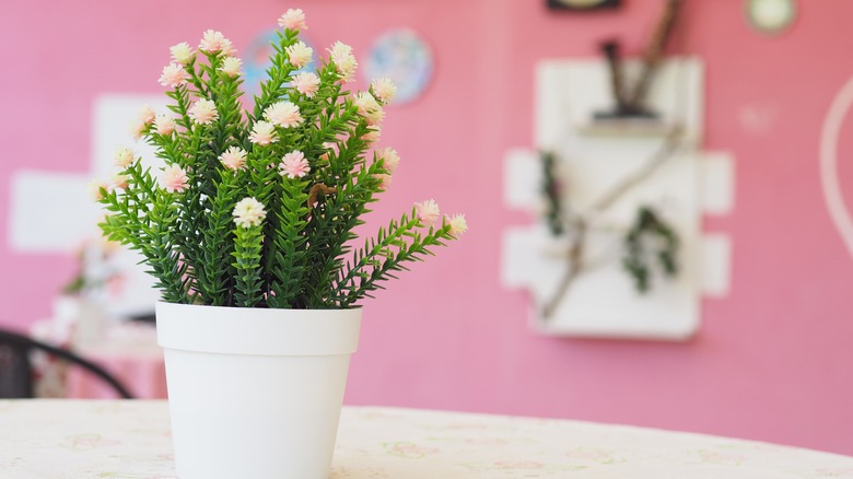 fake flowers in a vase on a table