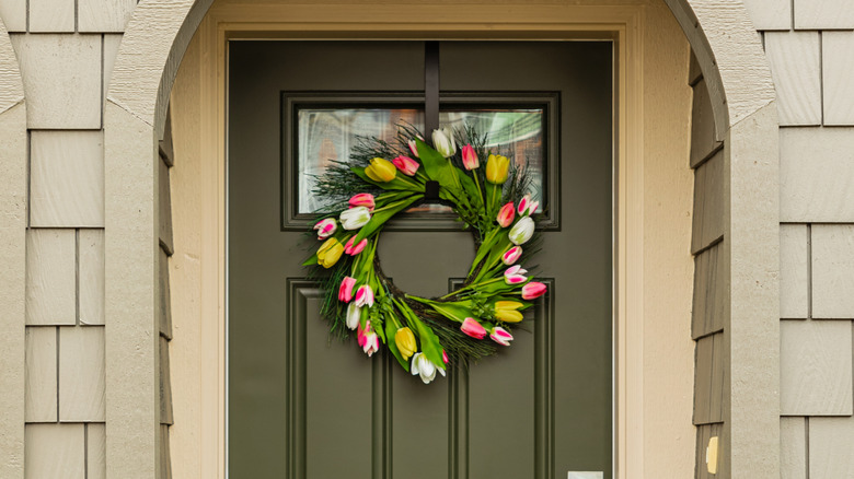 A spring wreath hanging on a front door