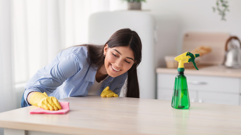 woman cleaning dining table