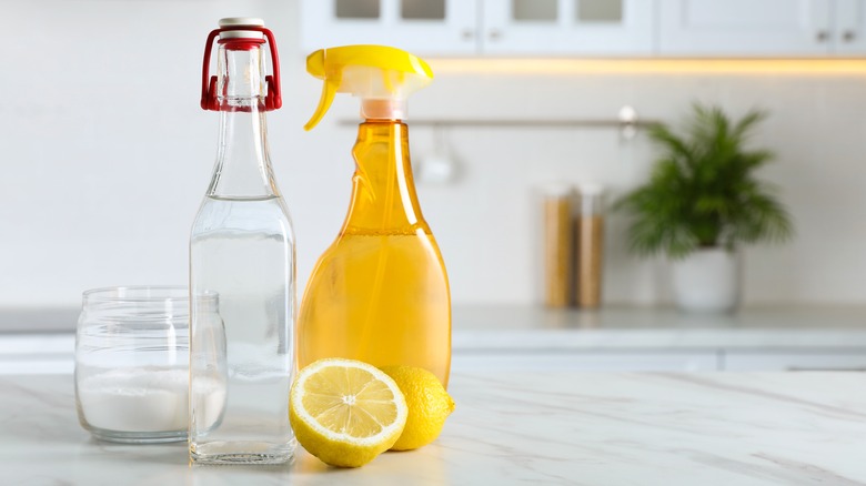 Lemon cleaner and vinegar on kitchen countertop