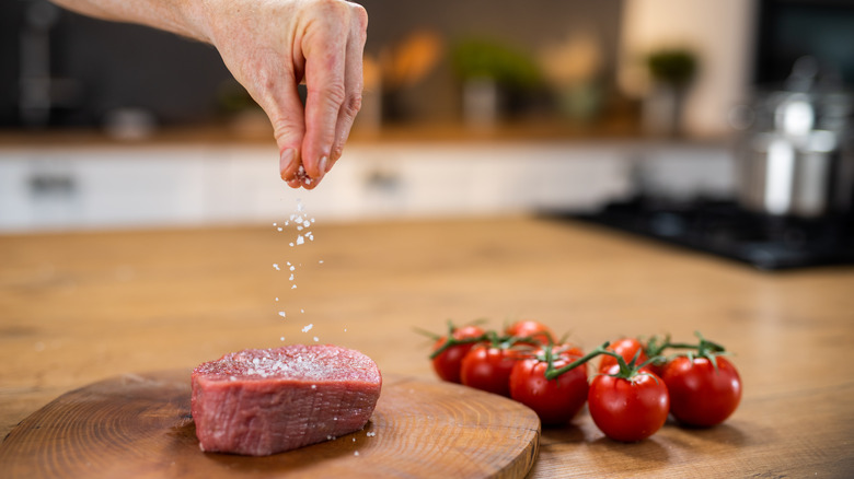 Hand seasoning meat