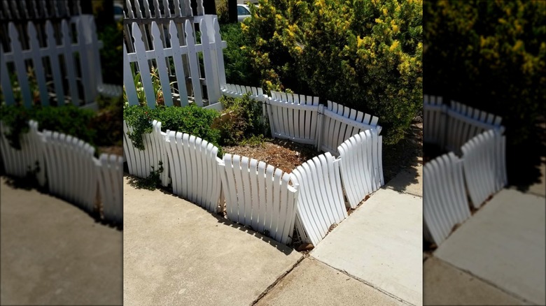 repurposed white lawn chair fence