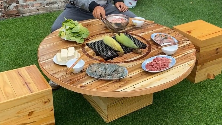 wooden table with built-in grill