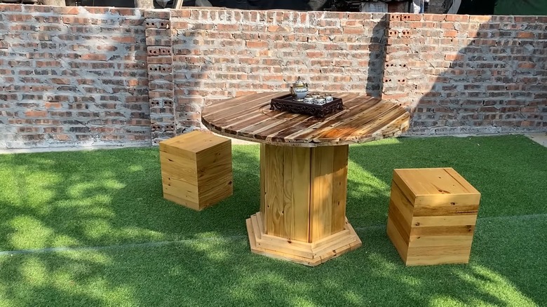 wooden table and stools in backyard