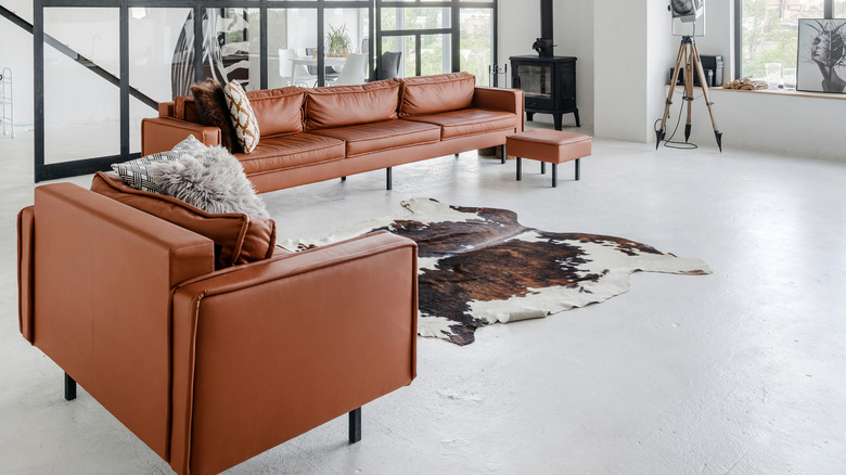 animal rug with leather furniture