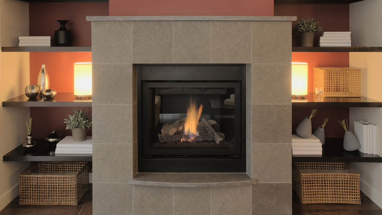 Modern fireplace in home with stylish marble surround