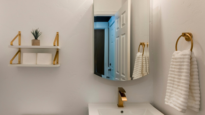 Mounted marble shelves on bathroom wall matching the sink countertop