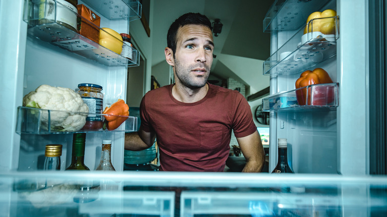 Man looking in fridge