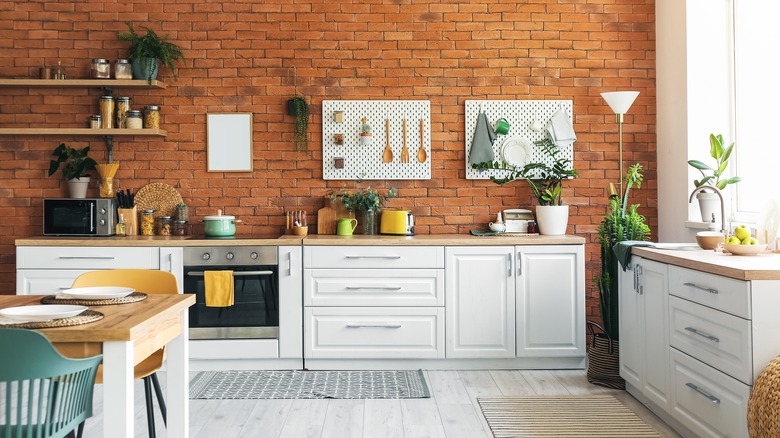 Modern kitchen with brick wall