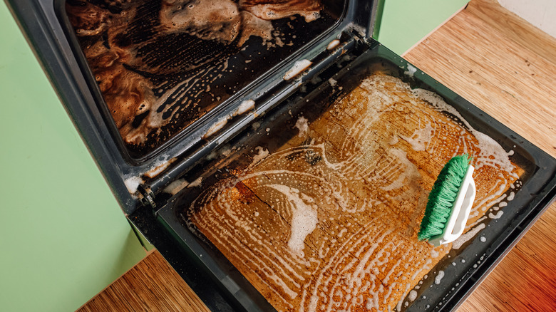 soap suds and brush in oven