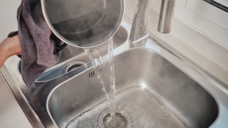 a pot of boiling water poured into drain