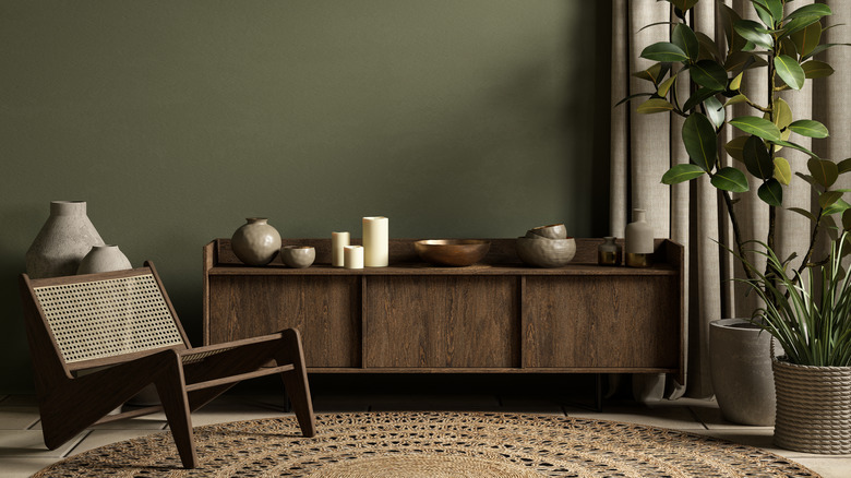 Moody green interior with sage walls and brown cabinet