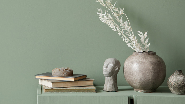 gray decorations against sage green wall