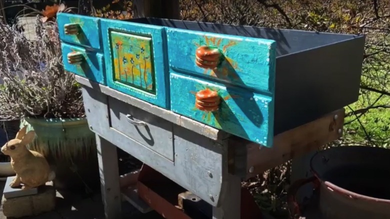 A beautiful hand-painted drawer turned into a mini glasshouse