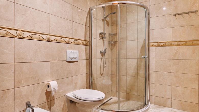 Sleek modern tile wall in bathroom with corner shower