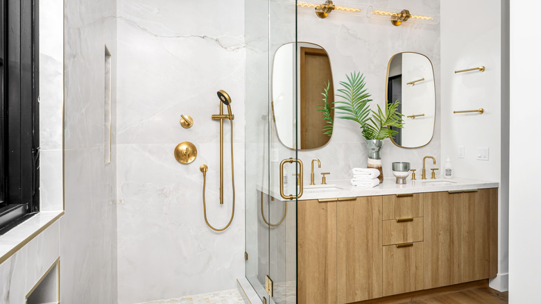 Golden shower head and fixtures in bathroom