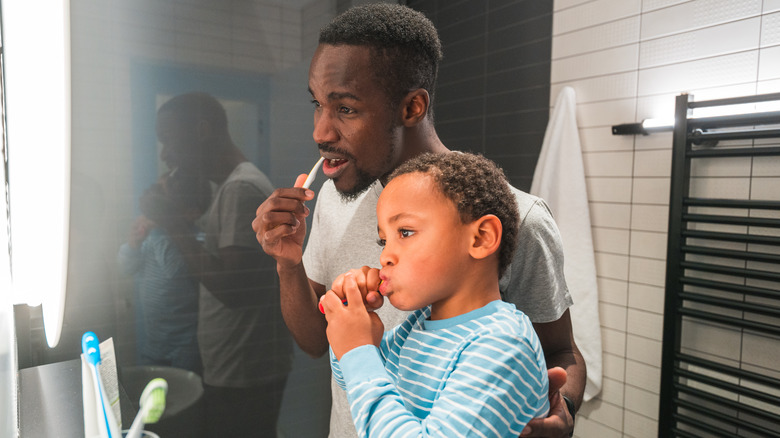 Father and son brushing teeth