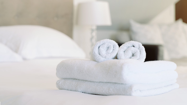 White towels placed on the edge of a bed