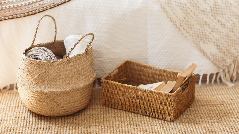 Two wicker baskets sitting on a jute rug