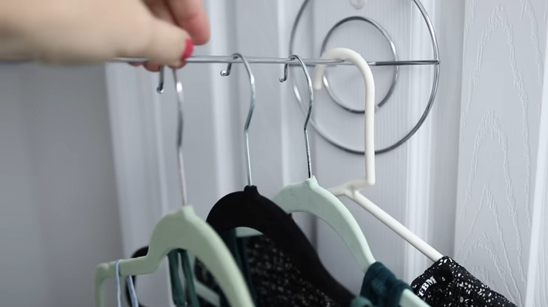 Dollar Tree paper towel holder used as a valet rod on closet door