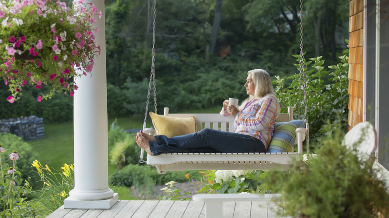 woman on white porch swing