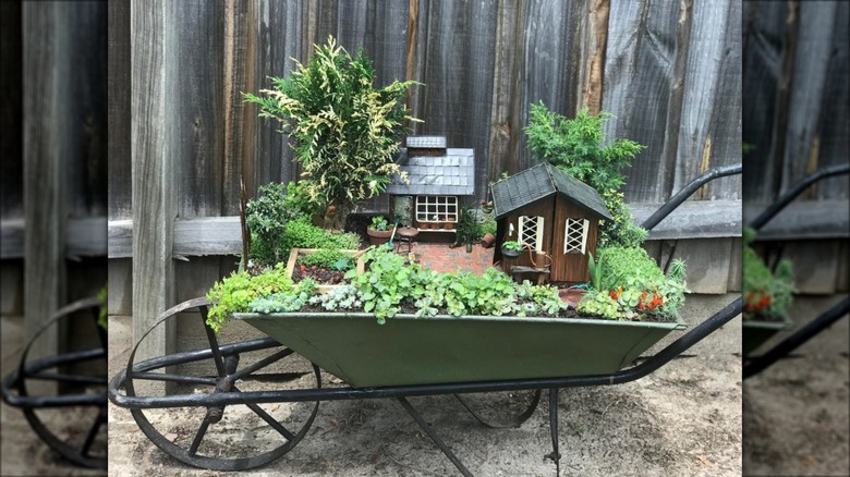 fairy garden in green wheelbarrow