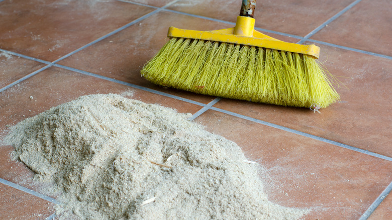 sawdust and broom on floor