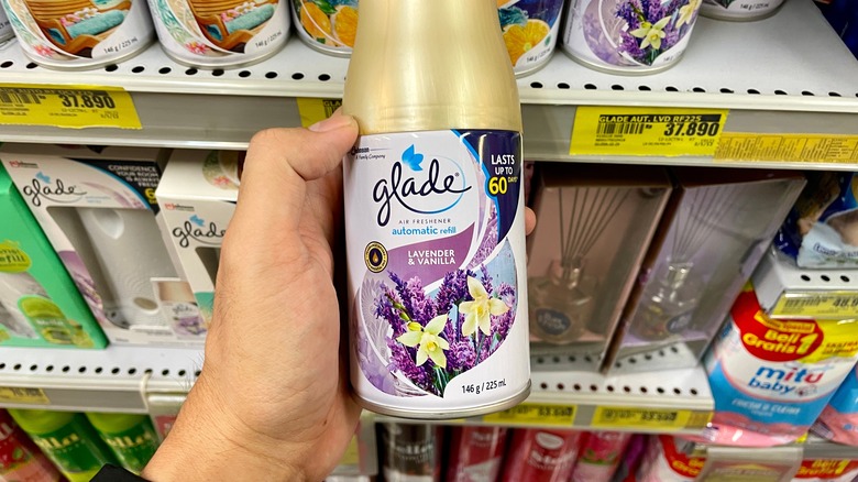 Hand holding Glade refill