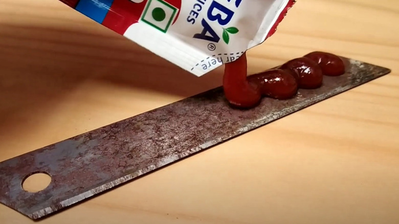 applying ketchup on rusty blade