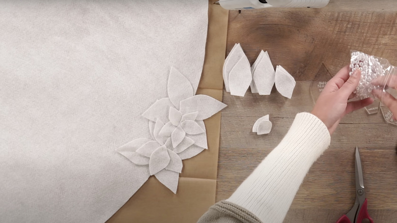 woman making white felt tree skirt