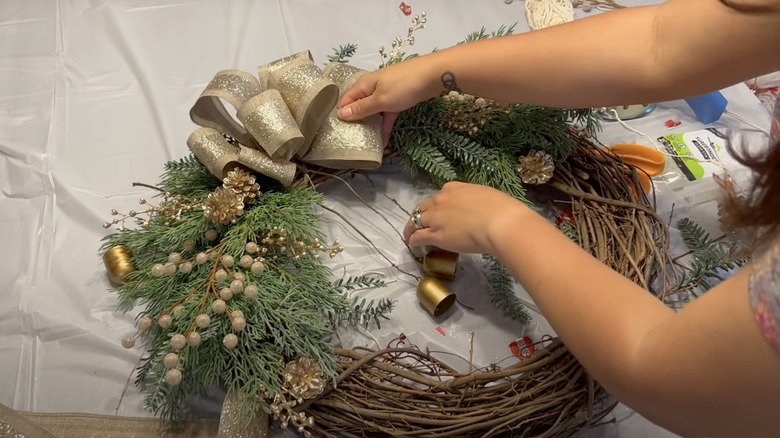 woman making DIY christmas wreath