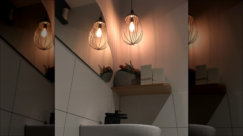 whisk hanging light in bathroom