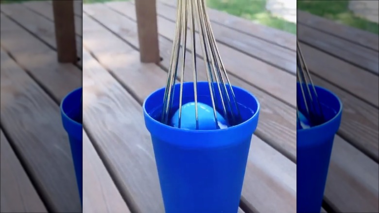 easter egg being dyed blue