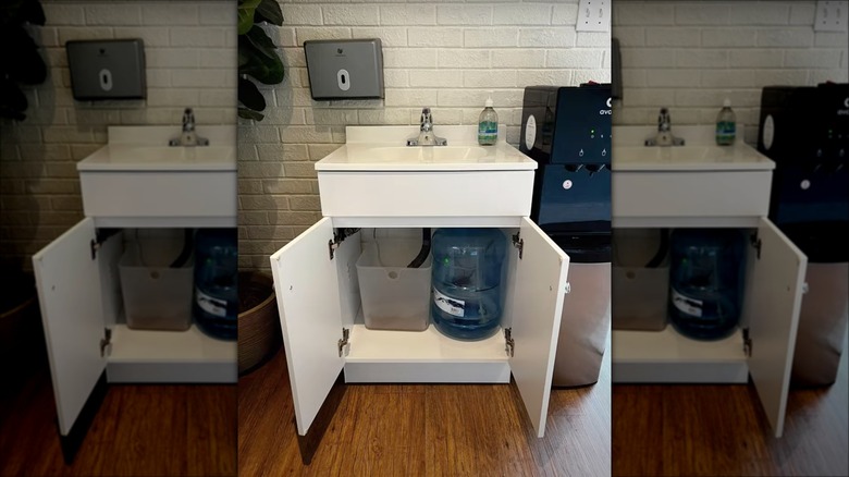 white portable sink in cabinet