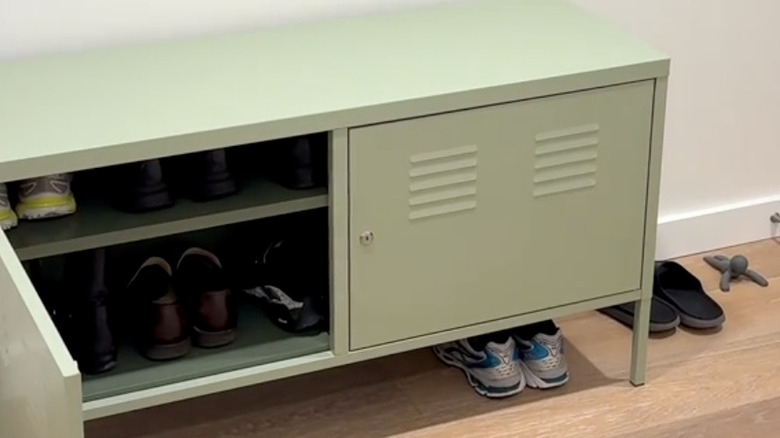 The IKEA PS Cabinet is used as a shoe storage solution.