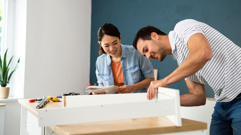 A couple building furniture